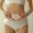 Cropped portrait of young female holding orchid flower on belly isolated over beige background. Pregnancy planning